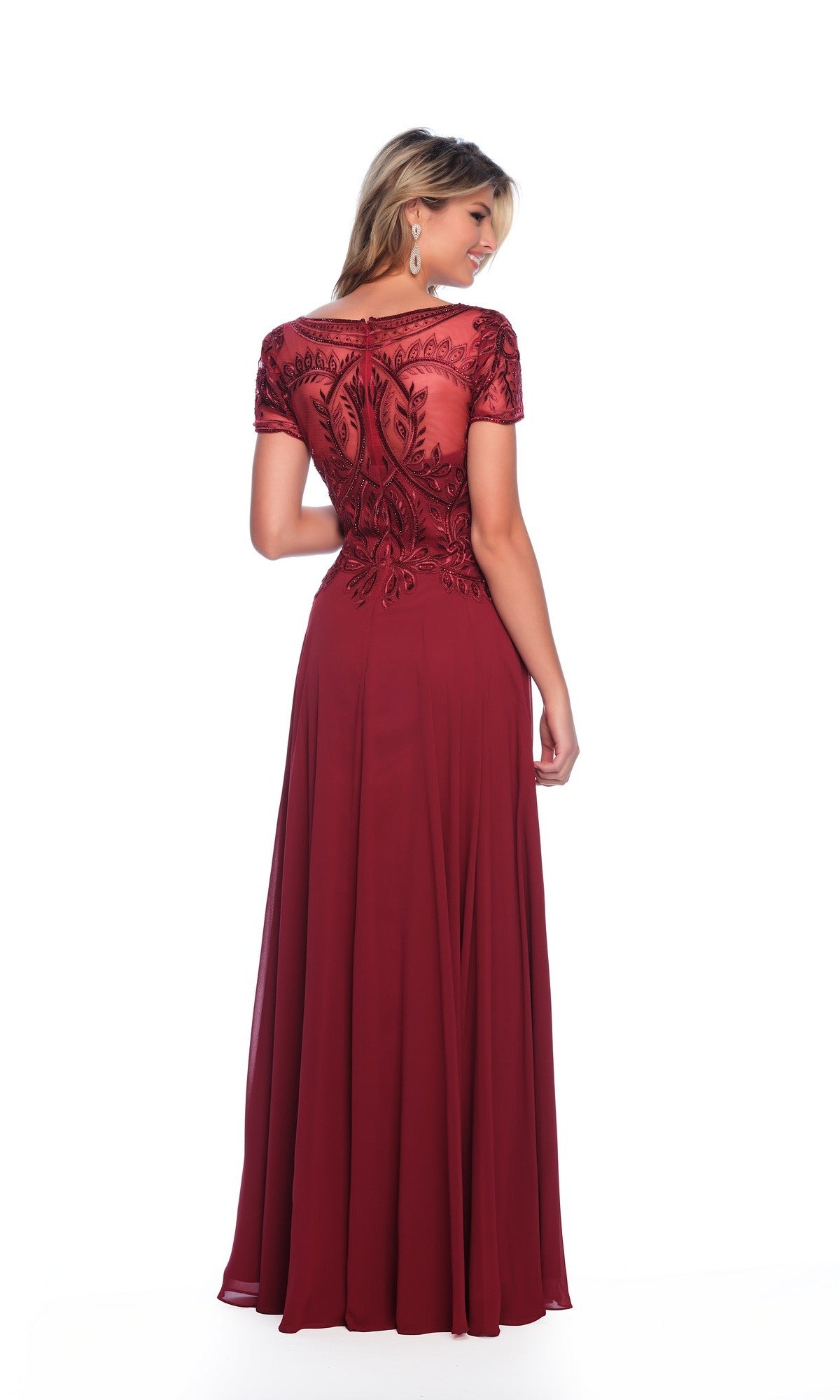 A woman stands facing away against a plain white background, wearing the Dave & Johnny A9071 short sleeve formal dress, a floor-length A-line gown featuring intricate lace detailing on the bodice.